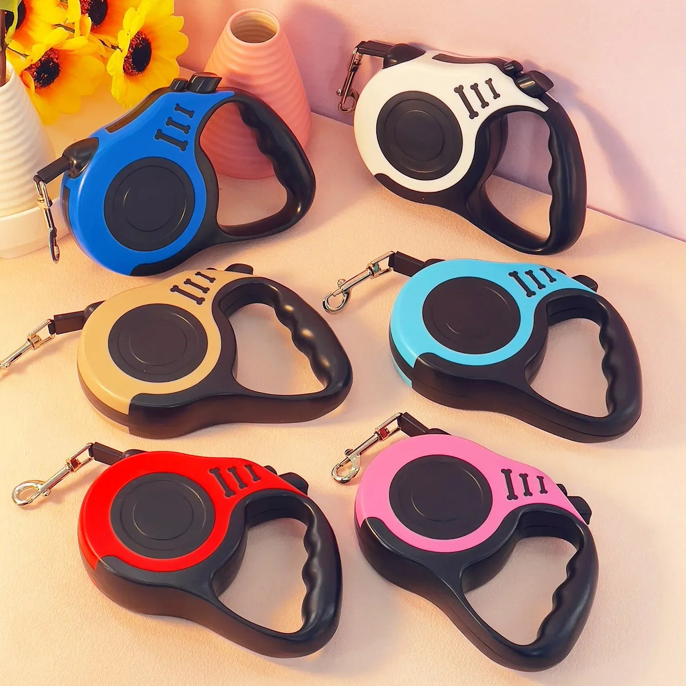 retractable dog leash with ergonomic handle and metal clip for attaching to a collar or harness
