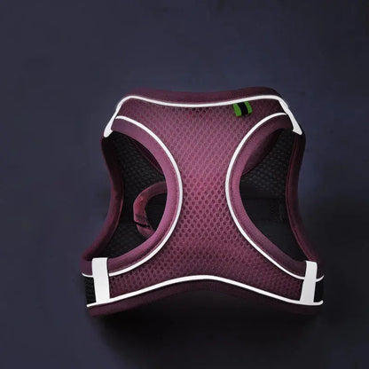 Reflective breathable mesh pet harness with reflective strips, adjustable straps, and a metal D-ring for leash attachment
